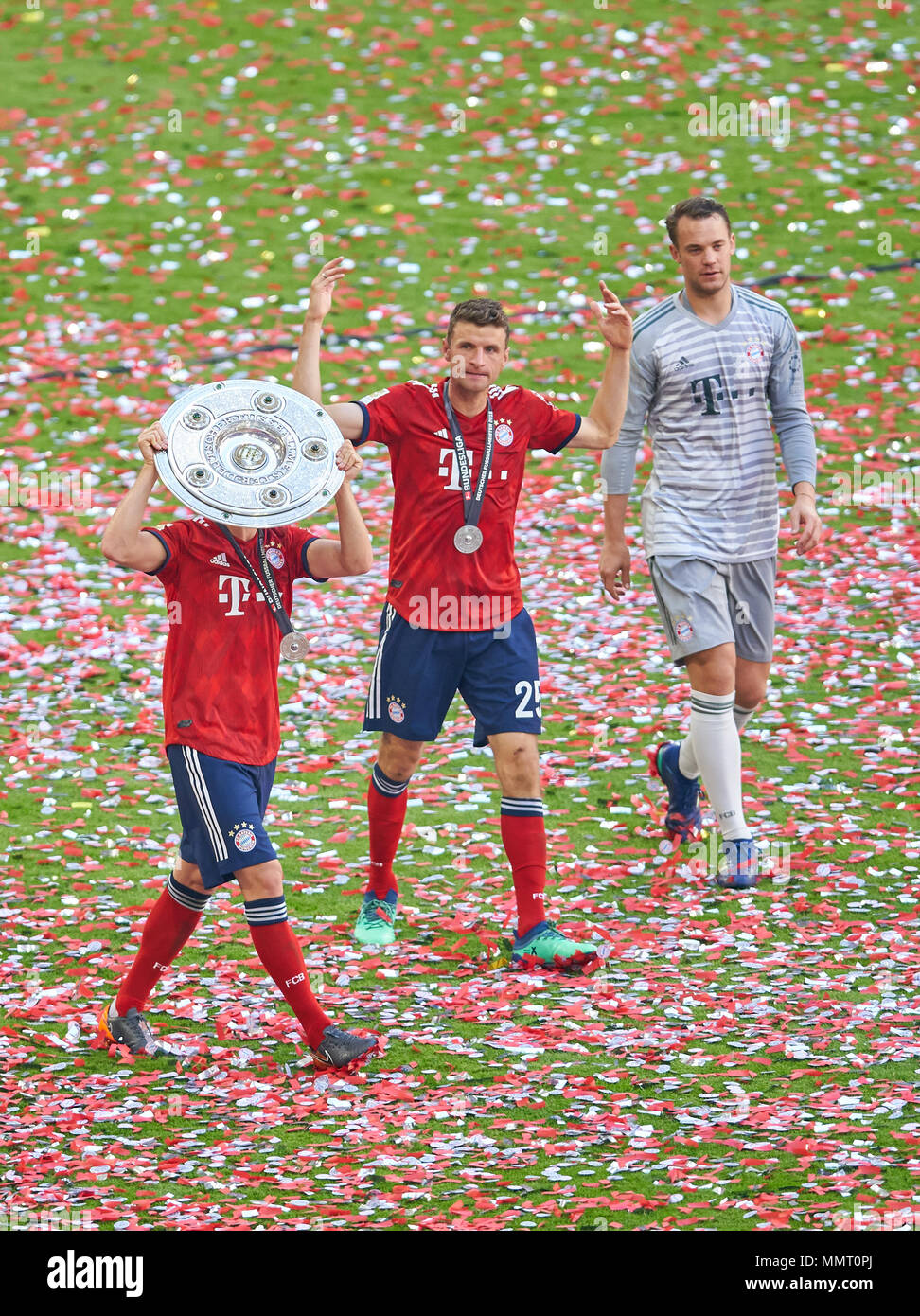 Munich, Germany.. 12th May, 2018. FC Bayern Munich Soccer, Munich, May 12,  2018 Thomas MUELLER, MÜLLER, FCB 25 , Manuel NEUER, FCB 1 Joshua KIMMICH,  FCB 32, with trophy, new shirt 2018/2019