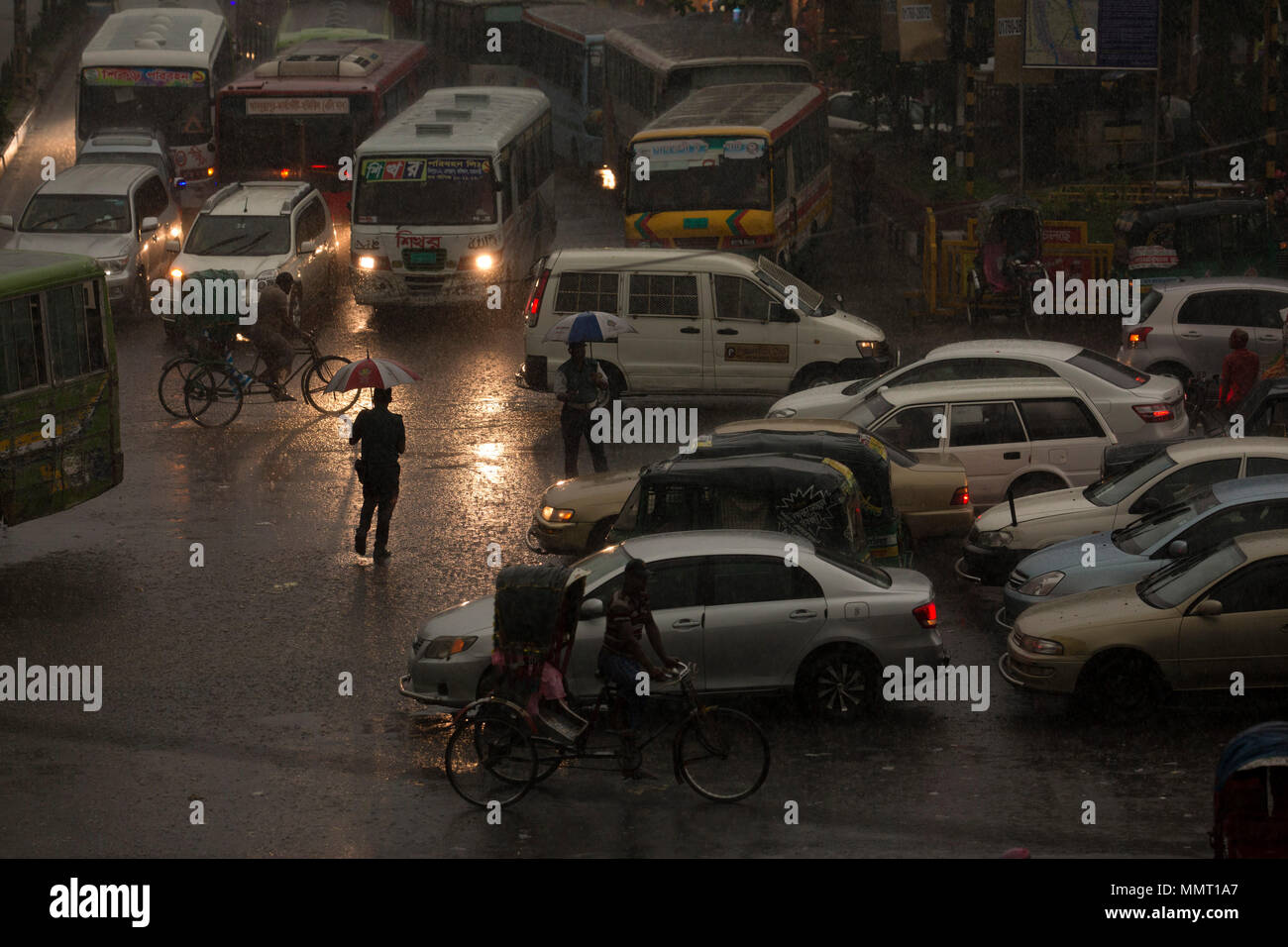 Dhaka, Bangladesh. 13th May 2018. Traffice police controls the vehicles during torrential rain in Dhaka , Bangladesh on May 13, 2018. Credit: zakir hossain chowdhury zakir/Alamy Live News Stock Photo