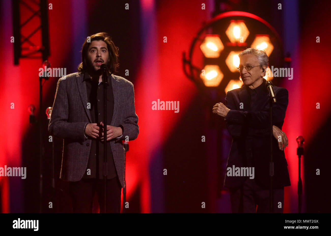 12 May 2018, Portugal, Lisbon: Last year's winner Salvador Sobral (l) and Brazilian singer Caetano Veloso perform at the finals of the 63rd Eurovision Song Contest. Photo: Jörg Carstensen/dpa Stock Photo