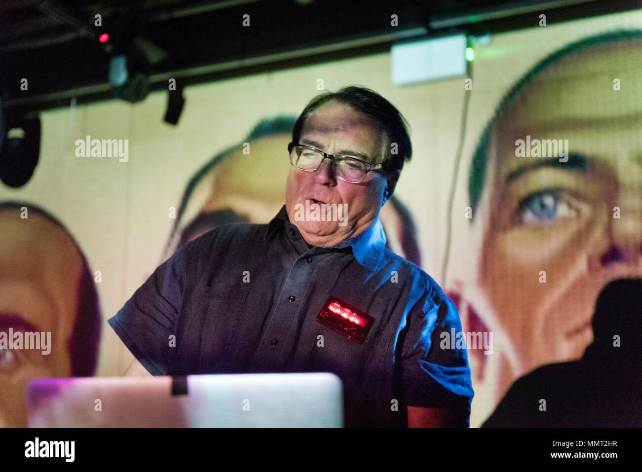 Leeds, UK. 12th May 2018. Wolfgang Flur, former member of German electronic band Kraftwerk performs a set at the Brudenell Social Club, Leeds, UK. In the background are projected images of Kraftwerk members. Credit: John Bentley/Alamy Live News Stock Photo