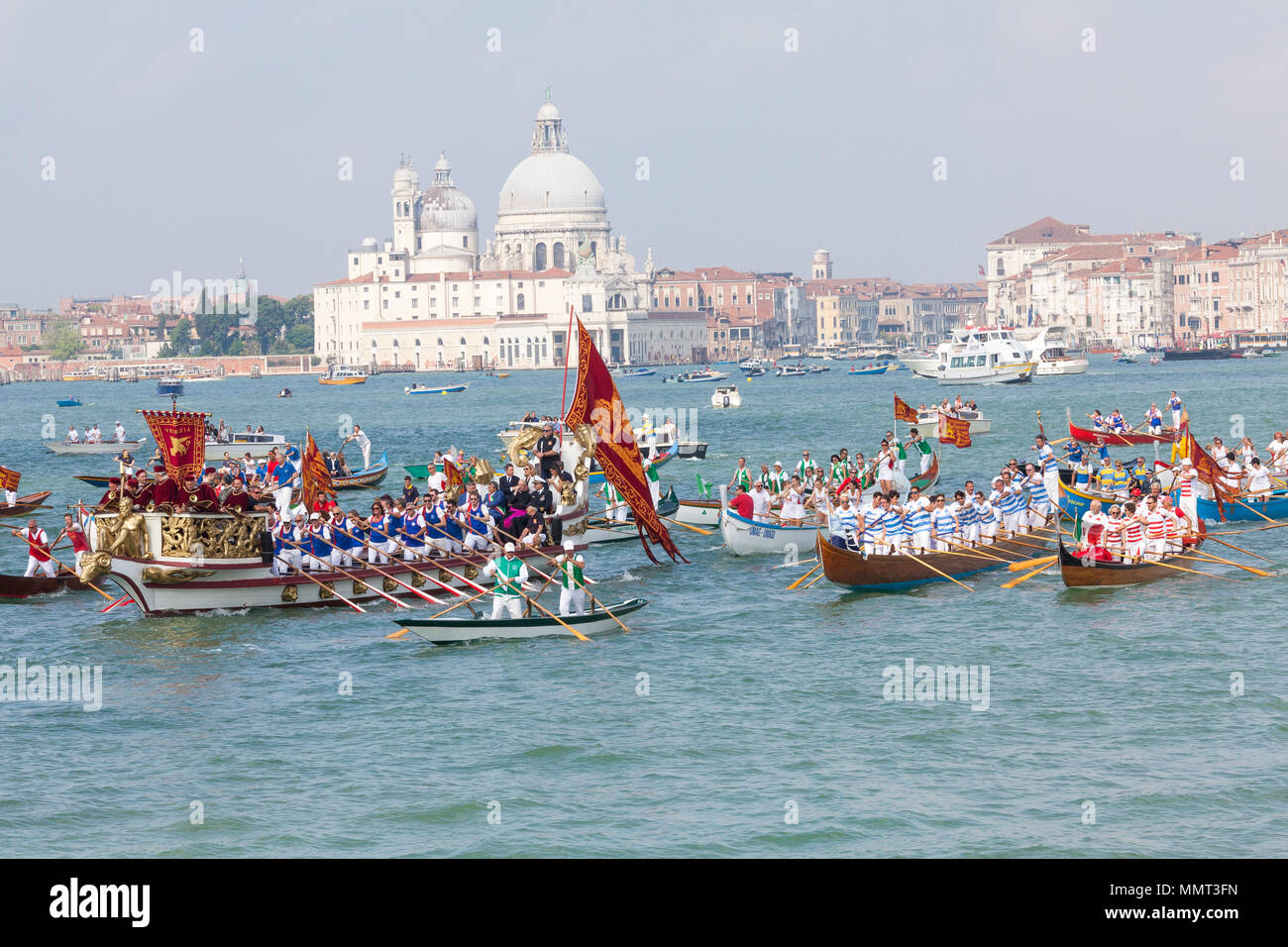 Venice, Veneto, Italy.  13th May 2018. View of St Marks Basin with the cortege of rowers in the boats accompanying the Serenissama ceremonial boat with the dignitaries to Lido during Festa de la Sensa for the blessing of the gold ring which is then tossed into the lagoon marrying Venice to the sea. Credit Mary Clarke/Alamy Live News Stock Photo