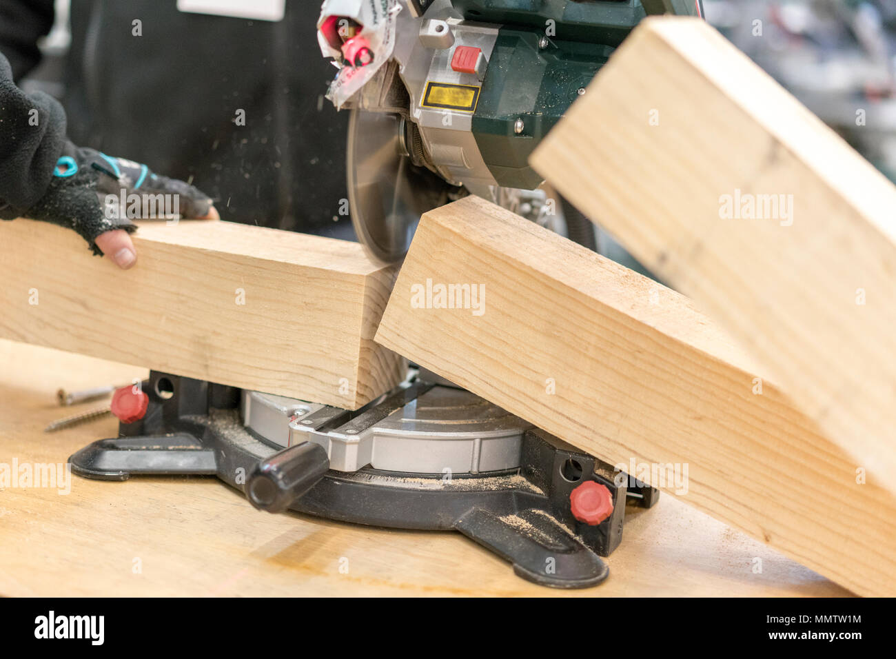 man carpenter cutting wood using table 