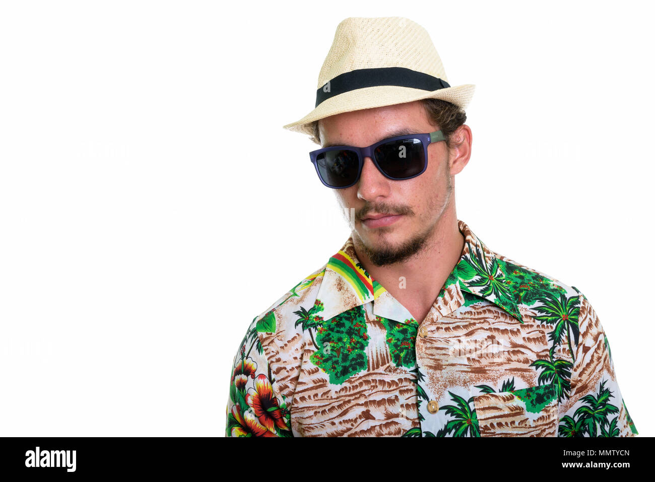 Studio shot of young handsome tourist man wearing sunglasses iso Stock Photo