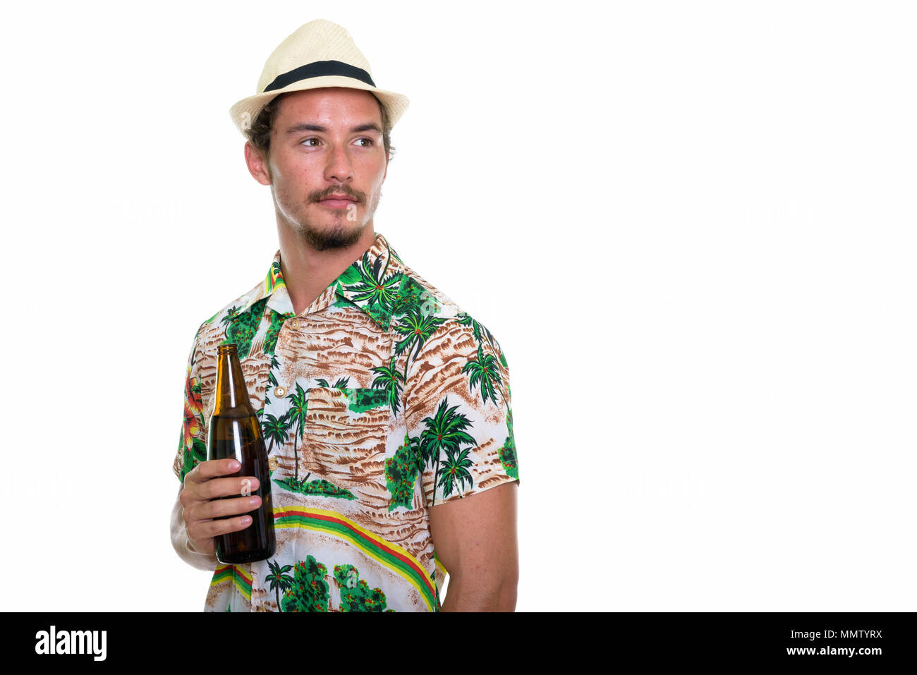 Studio shot of young handsome tourist man thinking while holding Stock ...