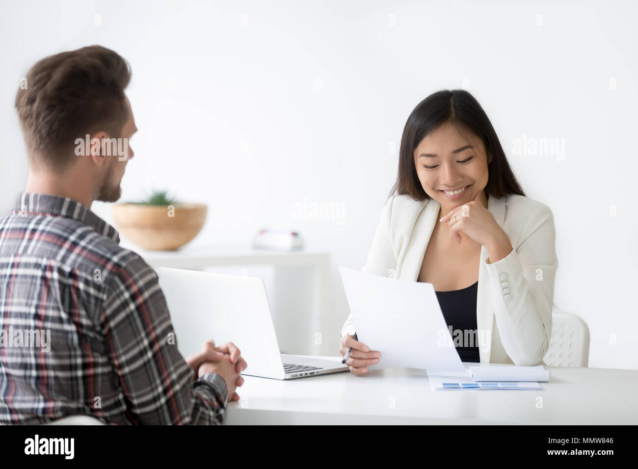 Good impression at interview concept, smiling asian hr reading r Stock Photo
