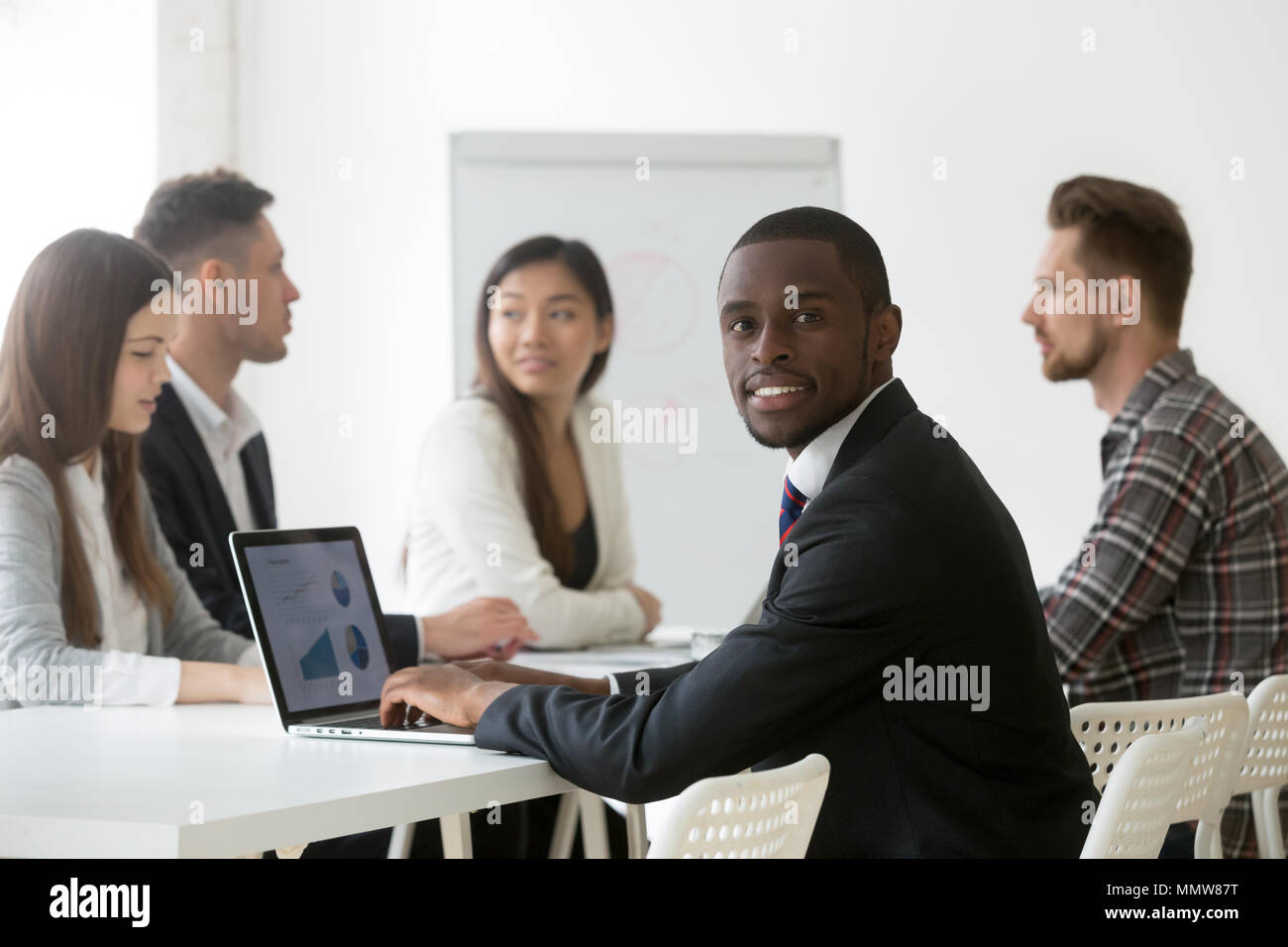 Black financial analyst using laptop analyzing statistics at mee Stock Photo