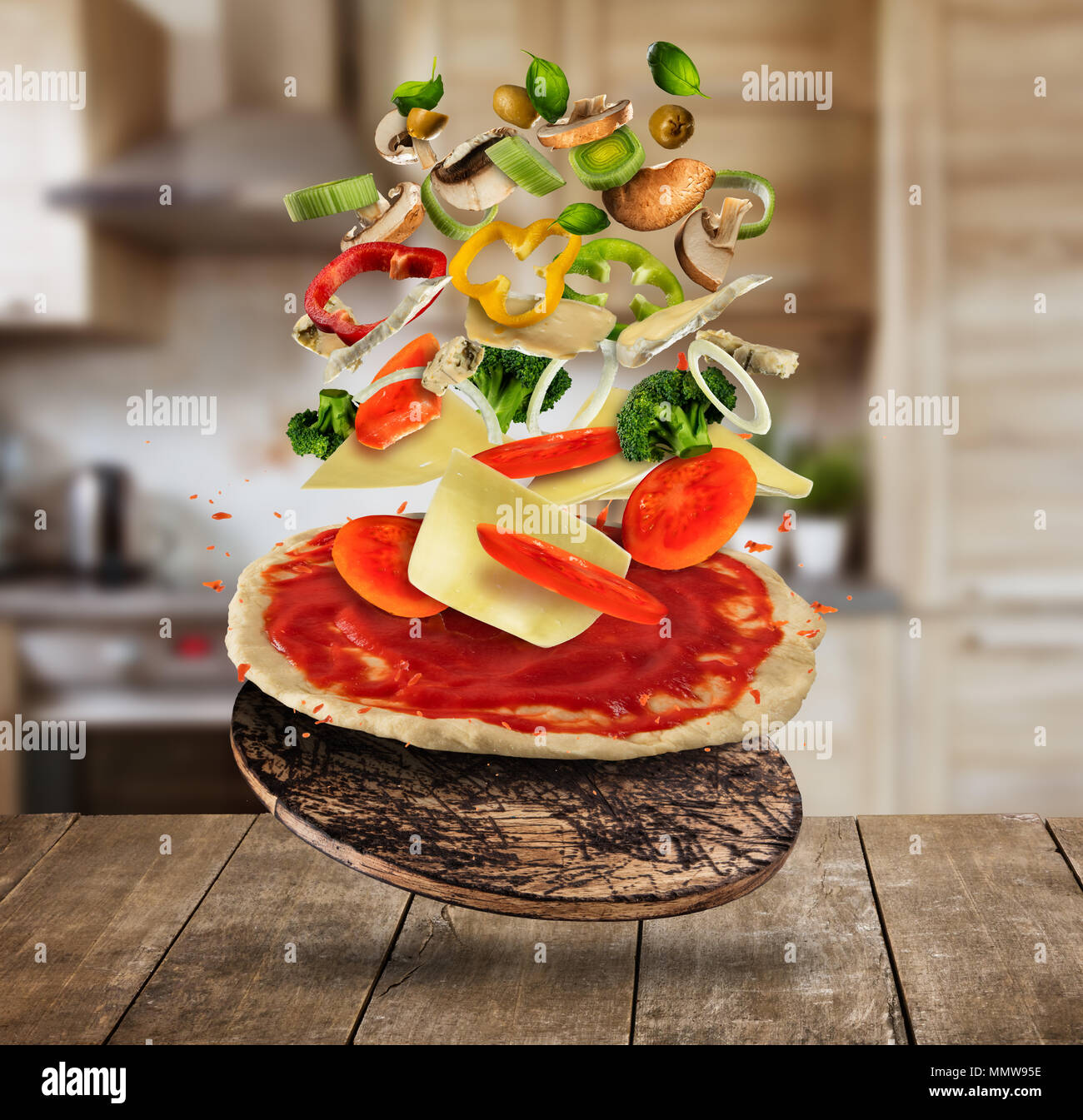 Flying pizza ingredients, served on wooden table. Concept of food  preparation, home made cooking Stock Photo - Alamy