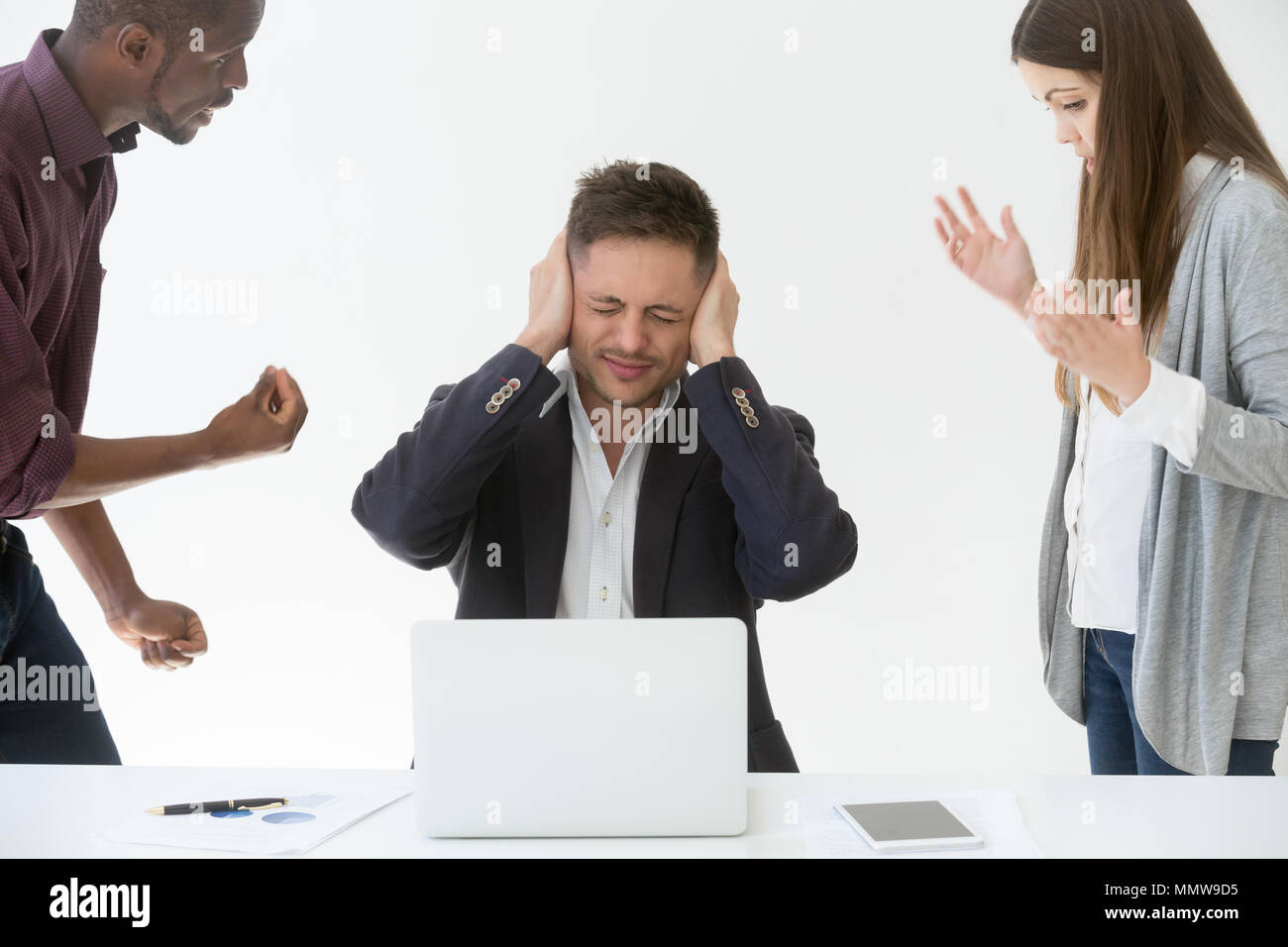 Tired from work or noise businessman closing ears with hands Stock Photo