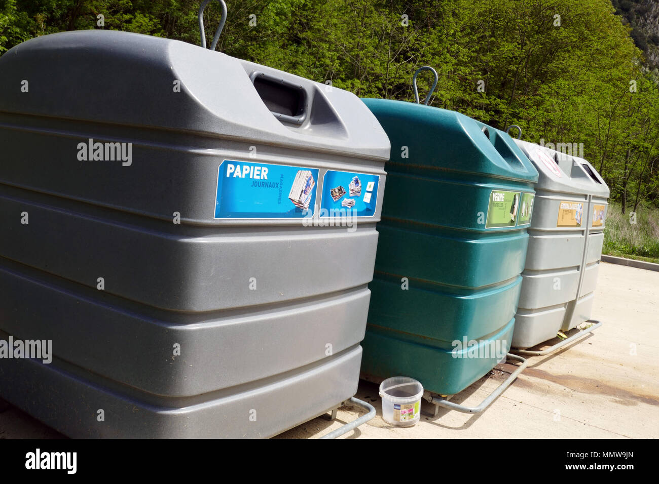 Large coloured recycling bins for glass paper and packaging Recycling bins in a row, lined up, Ariege, France, Stock Photo