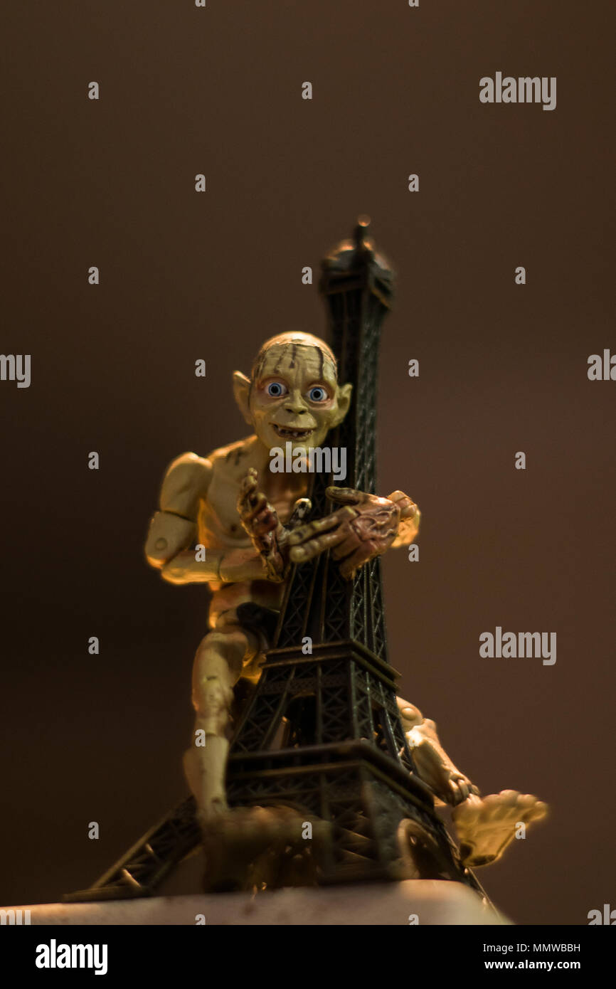 Lord of the rings, Gollum aka Smeagol toy grabbing the Eiffel Tower Stock Photo
