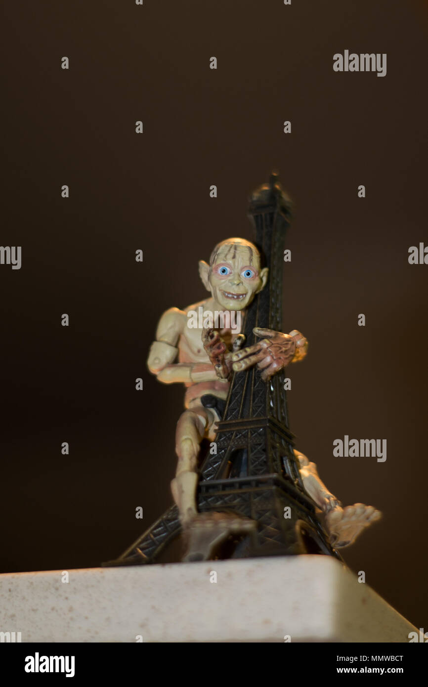 Lord of the rings, Gollum aka Smeagol toy grabbing the Eiffel Tower Stock Photo