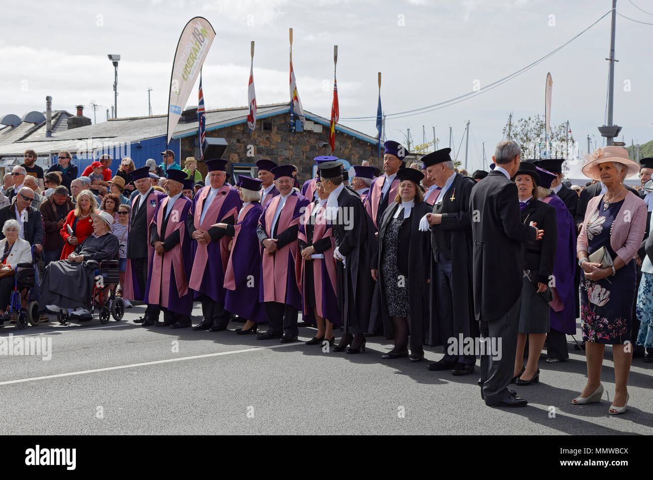Guernsey's Jurats in purple robes wait to begin their procession during Guernseys 73rd Liberation Day Celebrations. Stock Photo