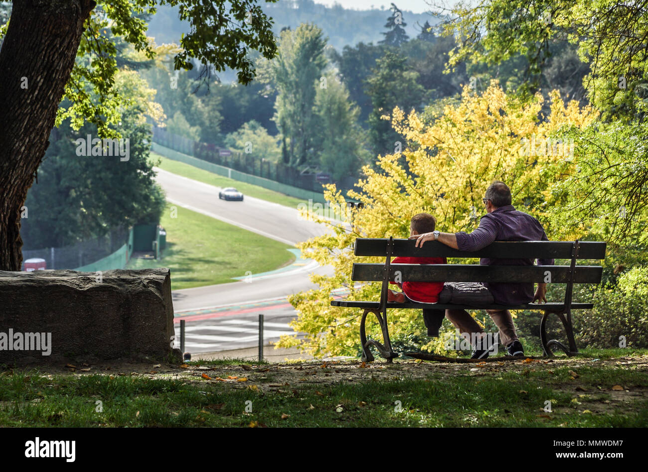 father and son watching sports competitions . Car race Stock Photo