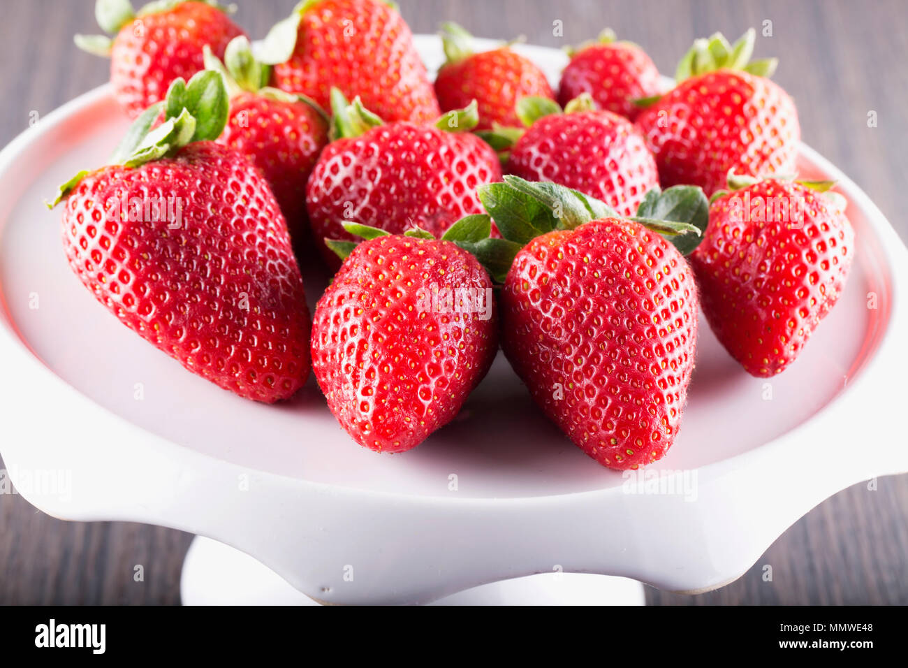 Strawberries over white riser, close up, horizontal image Stock Photo ...