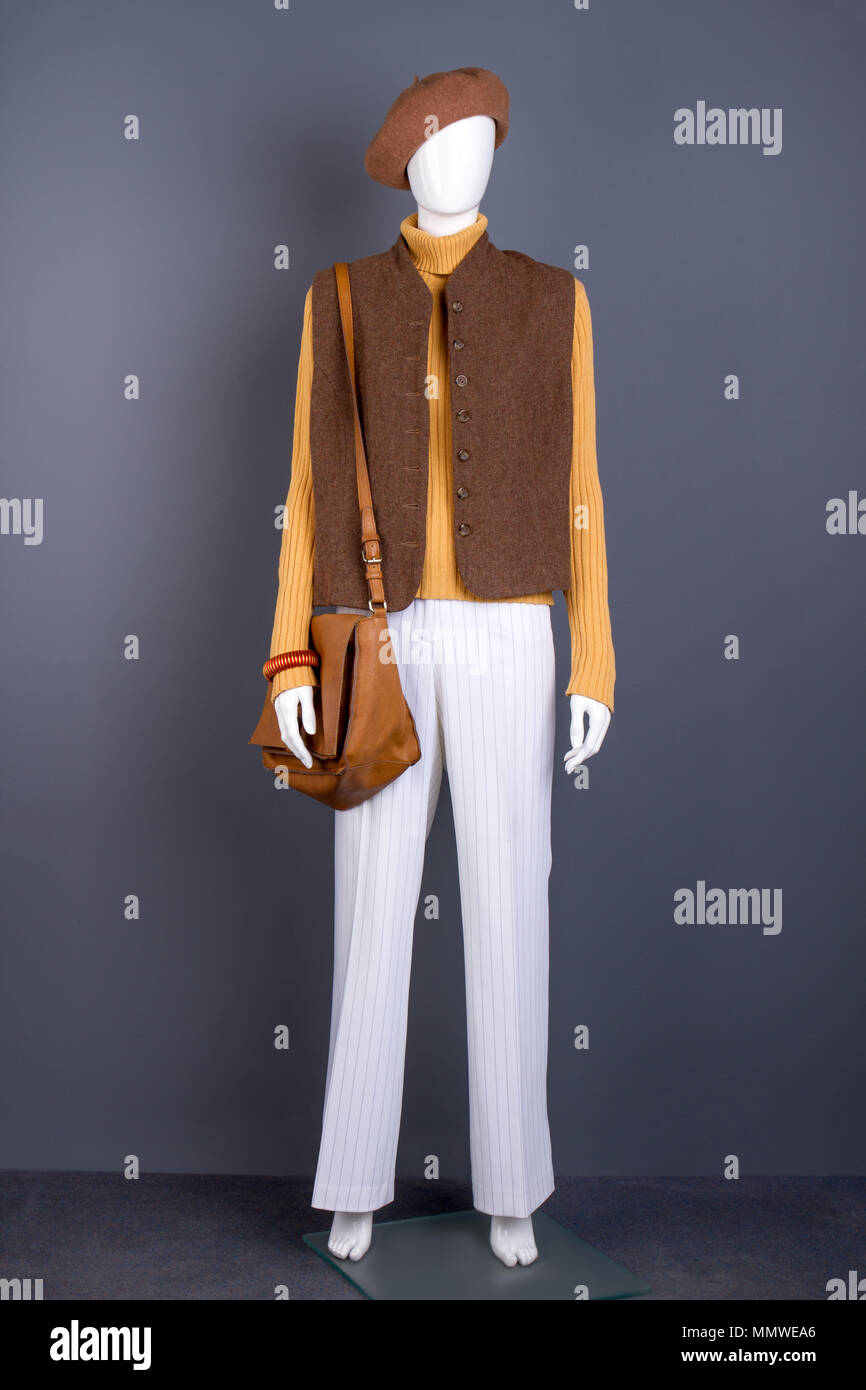 Female mannequin with brown clothes and accessories. Stock Photo