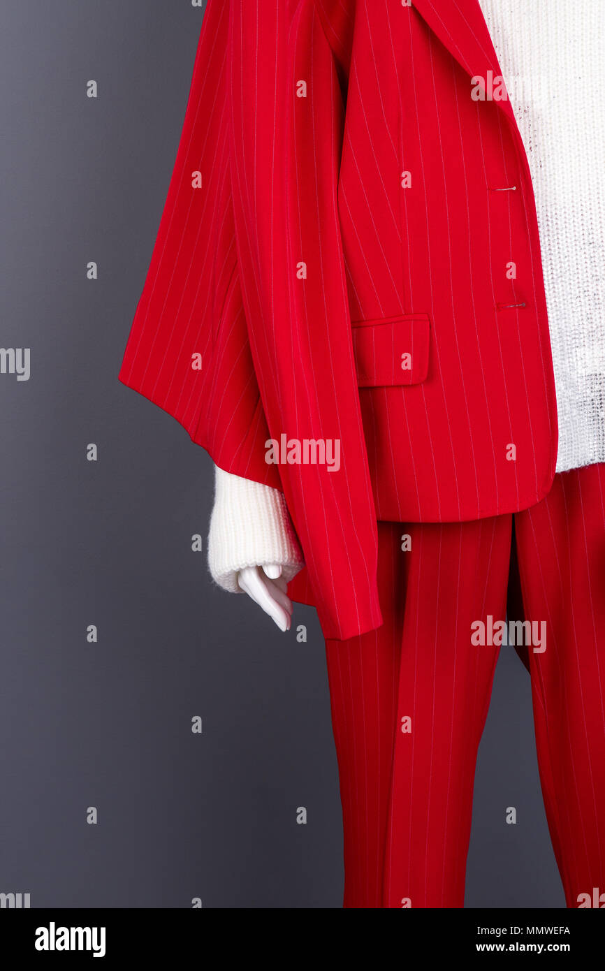 Red suit and white pullover for women. Stock Photo