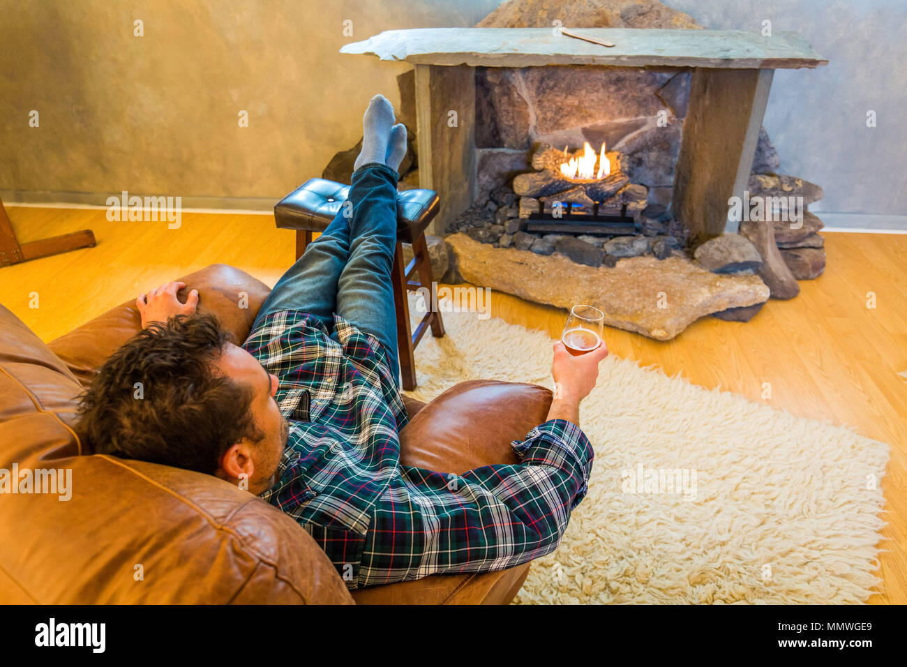 Chilling Out In Front Of Fireplace With Glass Of Beer Indoor Stock