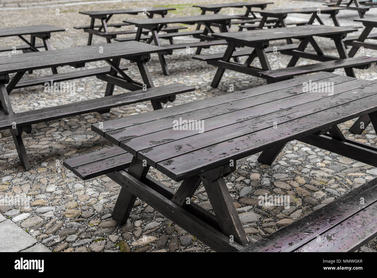 Series of wet empty wood tavern style tables Stock Photo Alamy