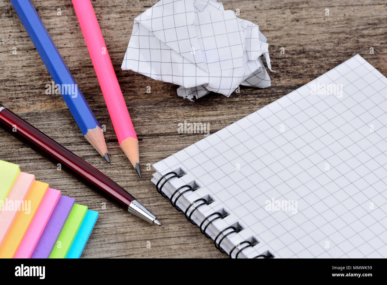 Empty notepad with pencils anc colorful notes on wooden table Stock Photo