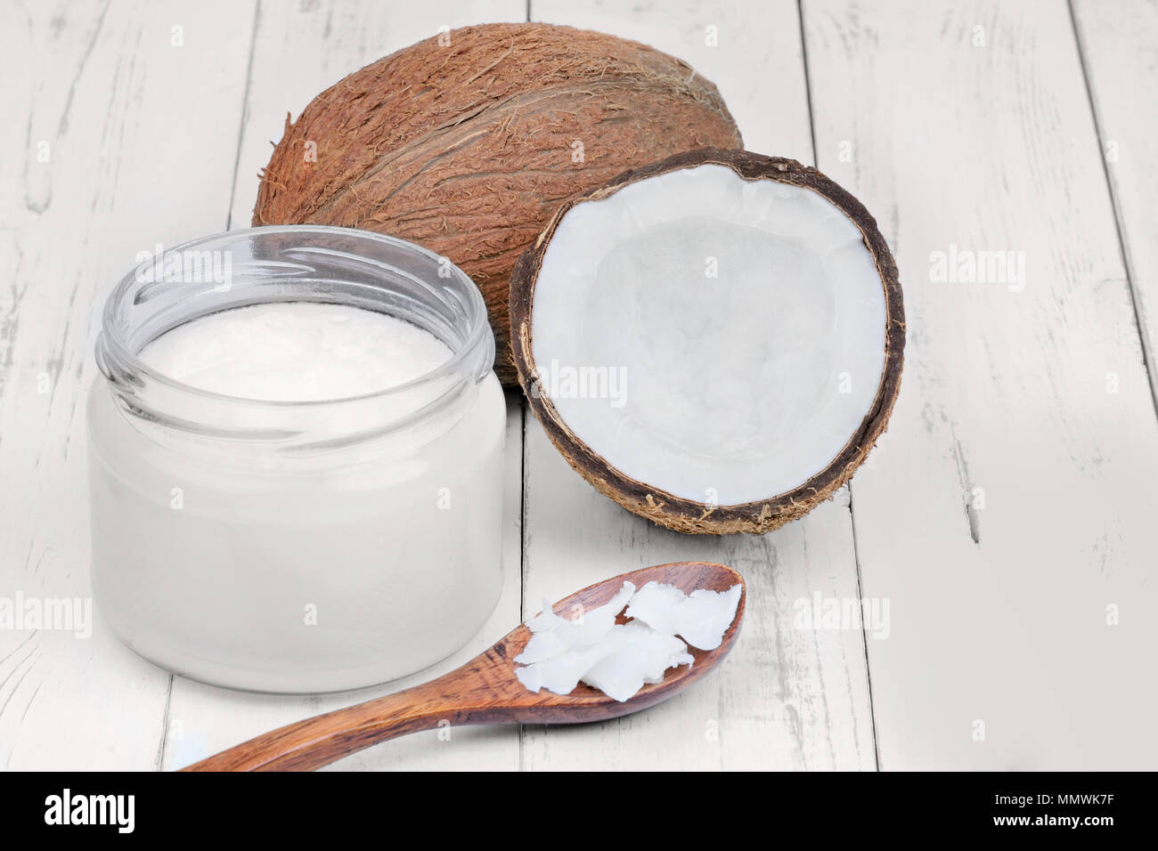 Organic coconut oil in a jar on wooden table Stock Photo Alamy