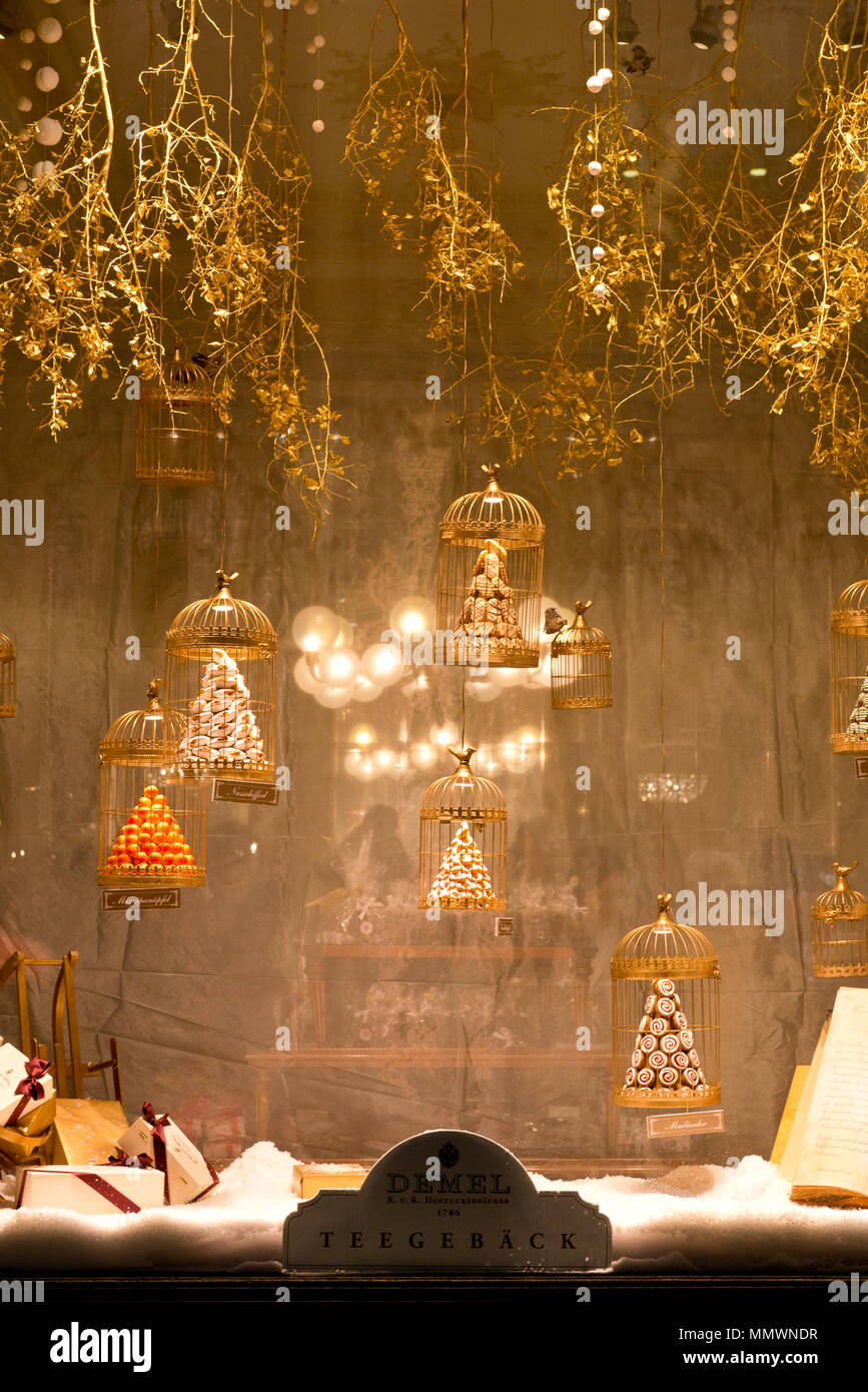 golden decorated Christmas shop window of Hofzuckerbaeckerei Demel in Vienna's Kohlmarkt with filigran branches and candies Stock Photo