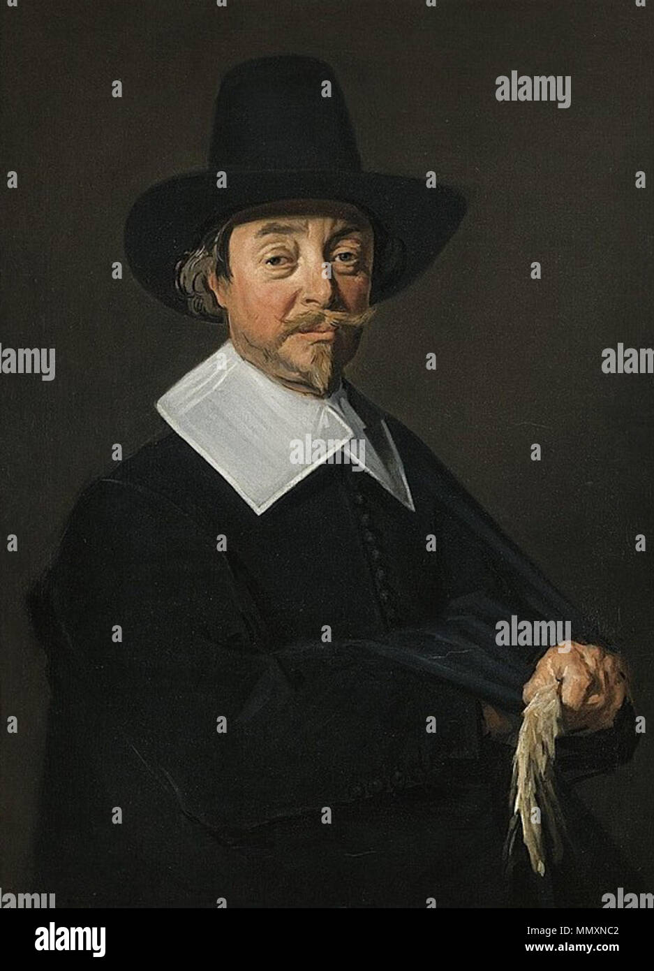 .  English: Portrait of a standing man holding a glove (or perhaps hops)  Portrait of a standing man. 1644/45. Frans Hals - portrait of a standing man Stock Photo