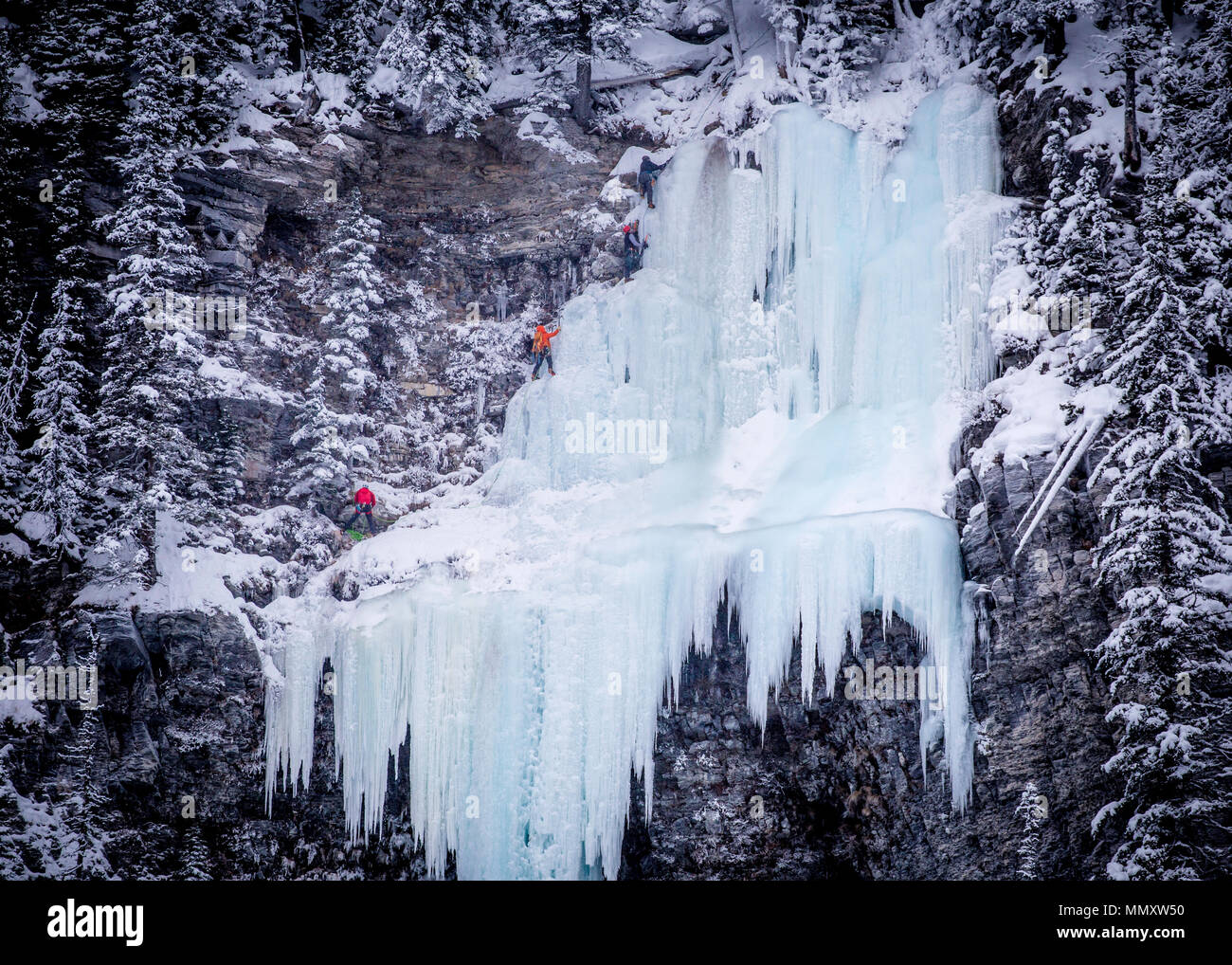 climbers climbing on a frozen waterfall Stock Photo