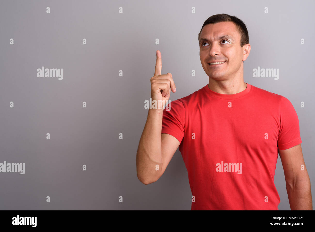 Man wearing red shirt against gray background Stock Photo