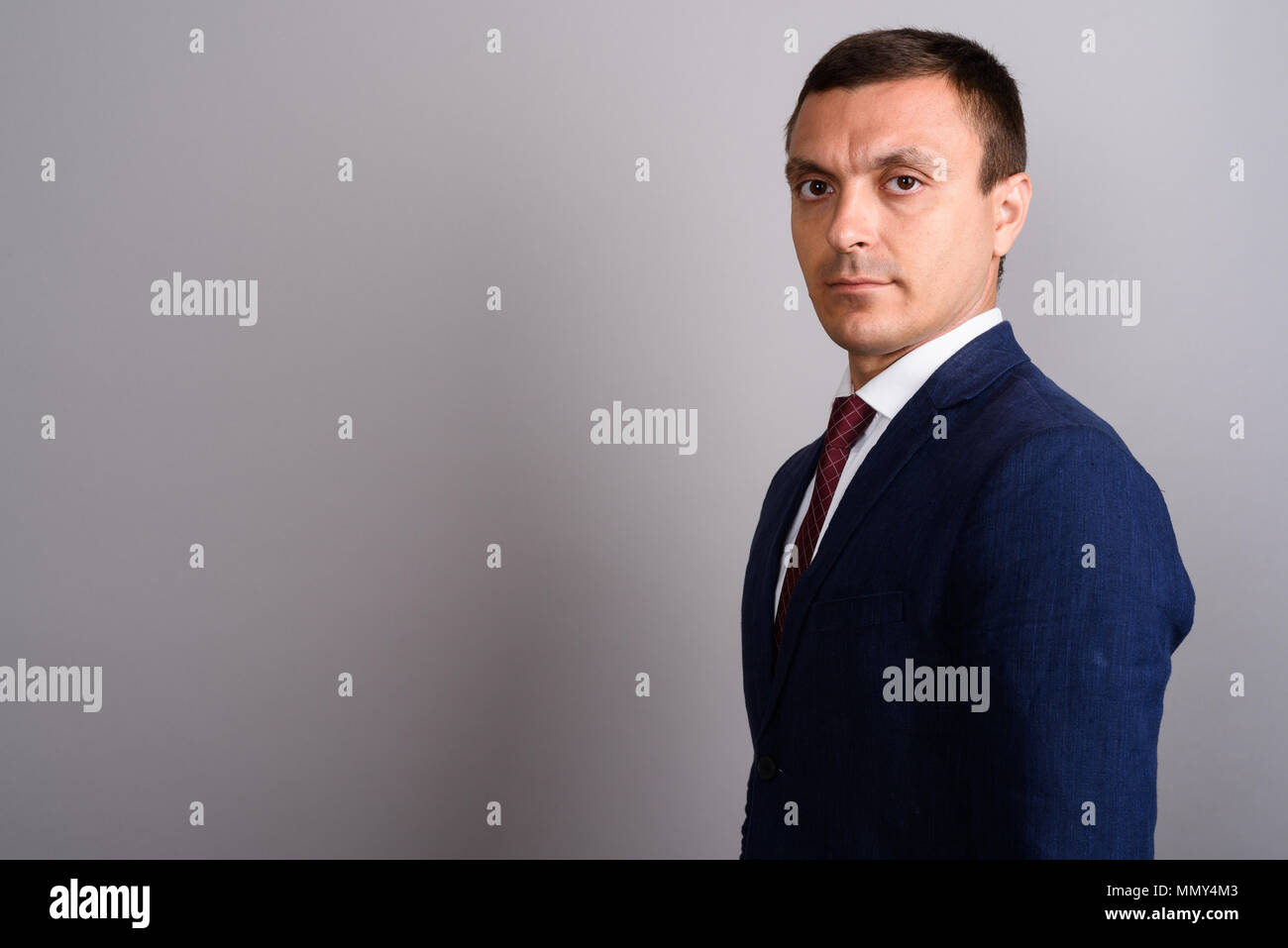 Businessman wearing suit against gray background Stock Photo