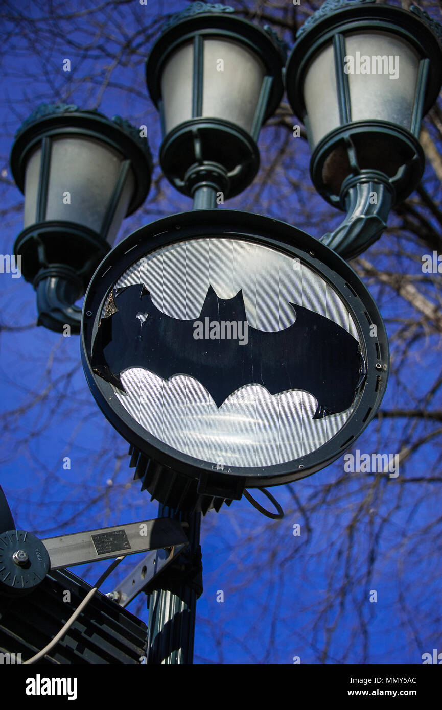 Batman laser projector under a street lamp, near Rzeszow Castle. Poland. Bat  symbol on a white background against a deep blue sky Stock Photo - Alamy