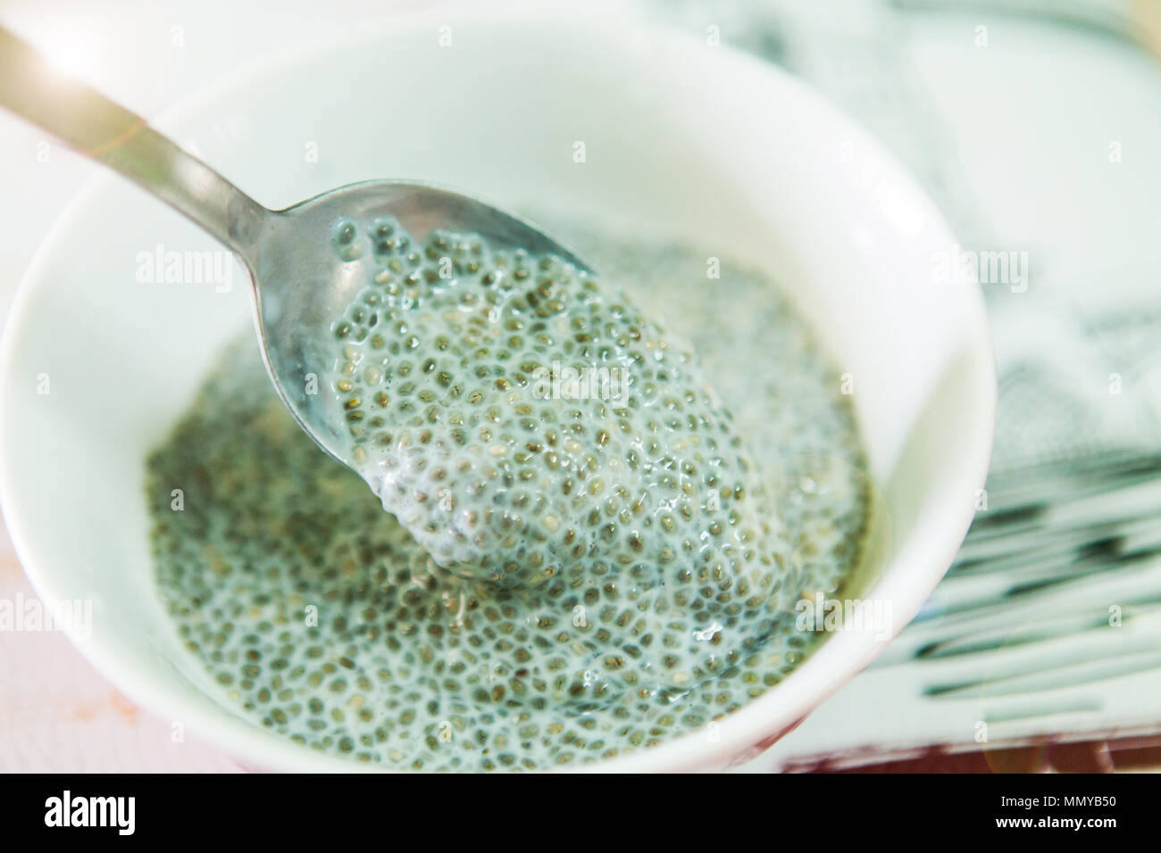 Spoon dig up a home cook meal of chia seeds soak with milk Stock Photo