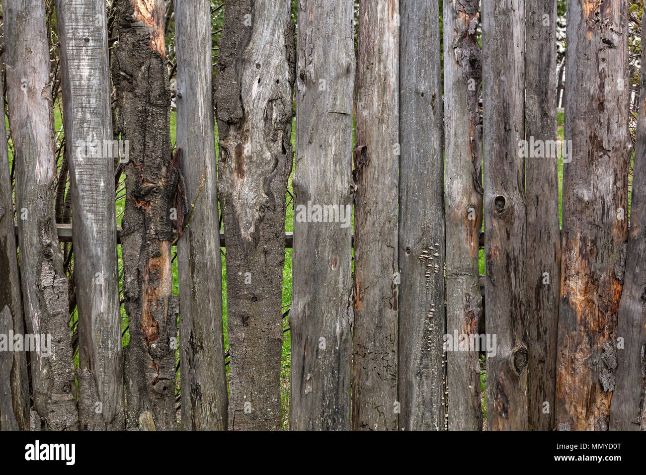 Close-up of an old wooden fence with a birdhouse in the village of a ...