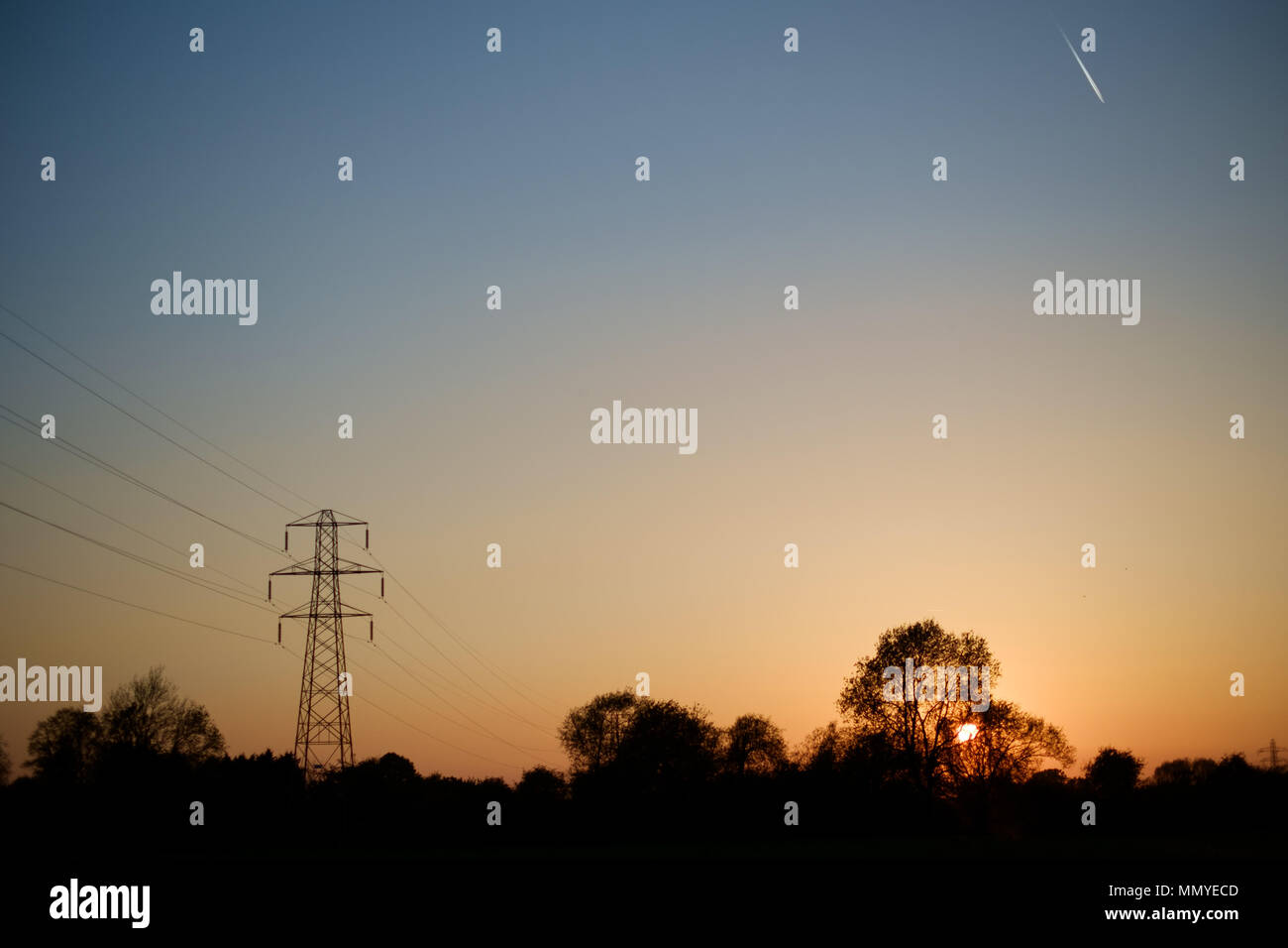 Electricity pylon at sunset in English countryside Stock Photo - Alamy
