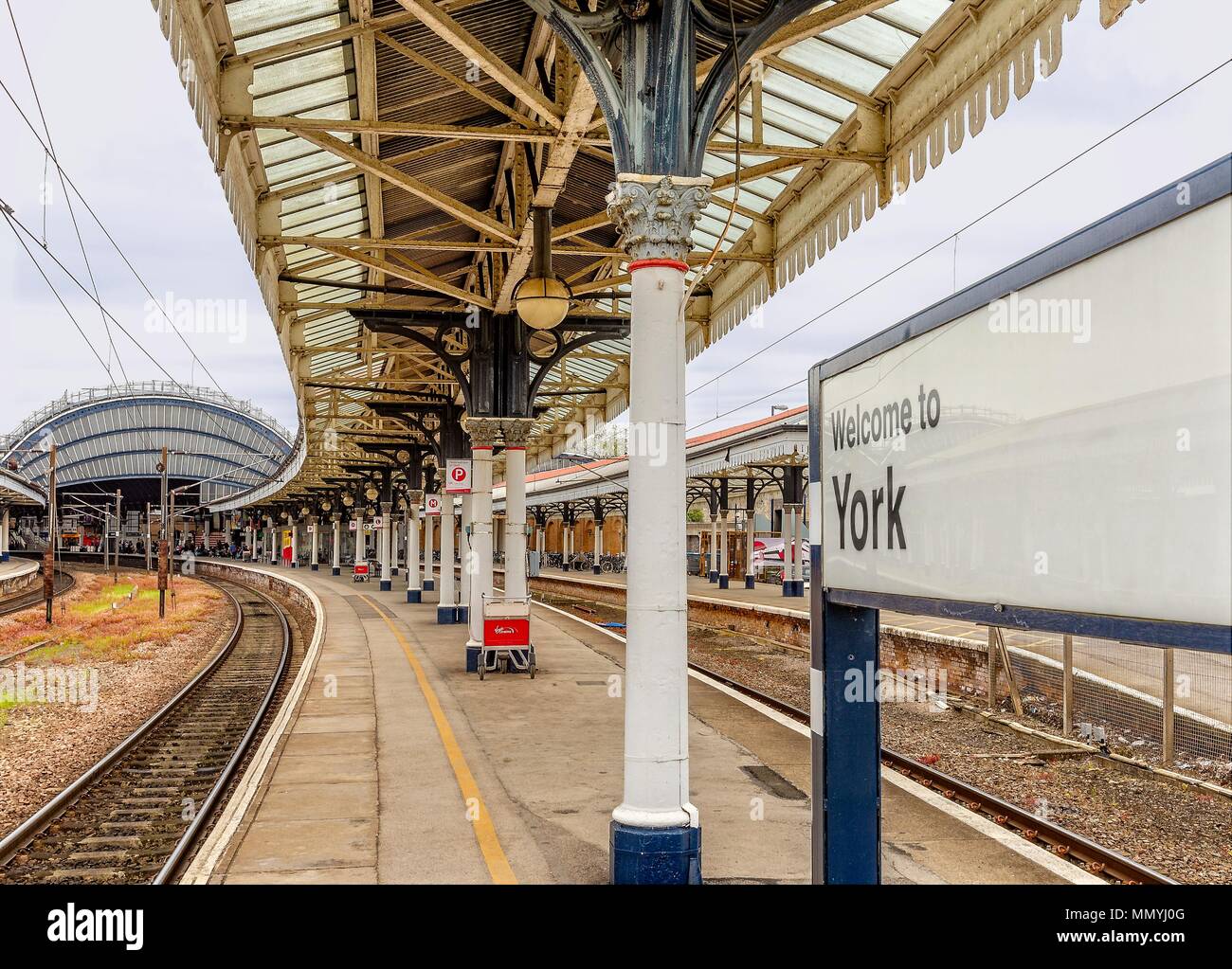 View of York railway station from the end of platform.  An ornate Victorian canopy is overhead. Stock Photo