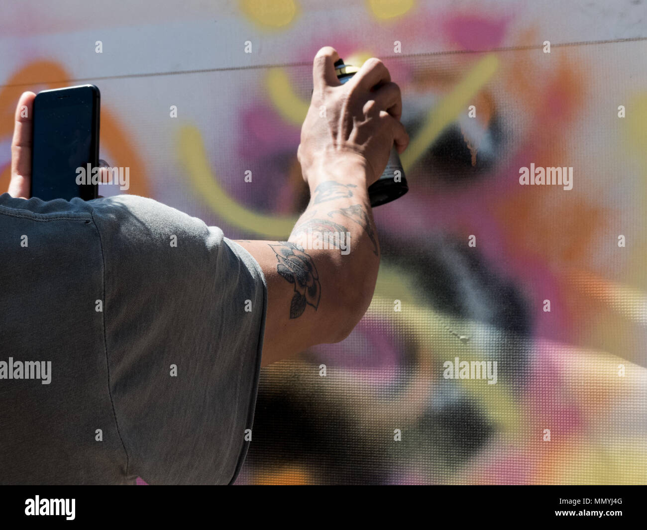 Young male hand tatto using paint spray background Stock Photo