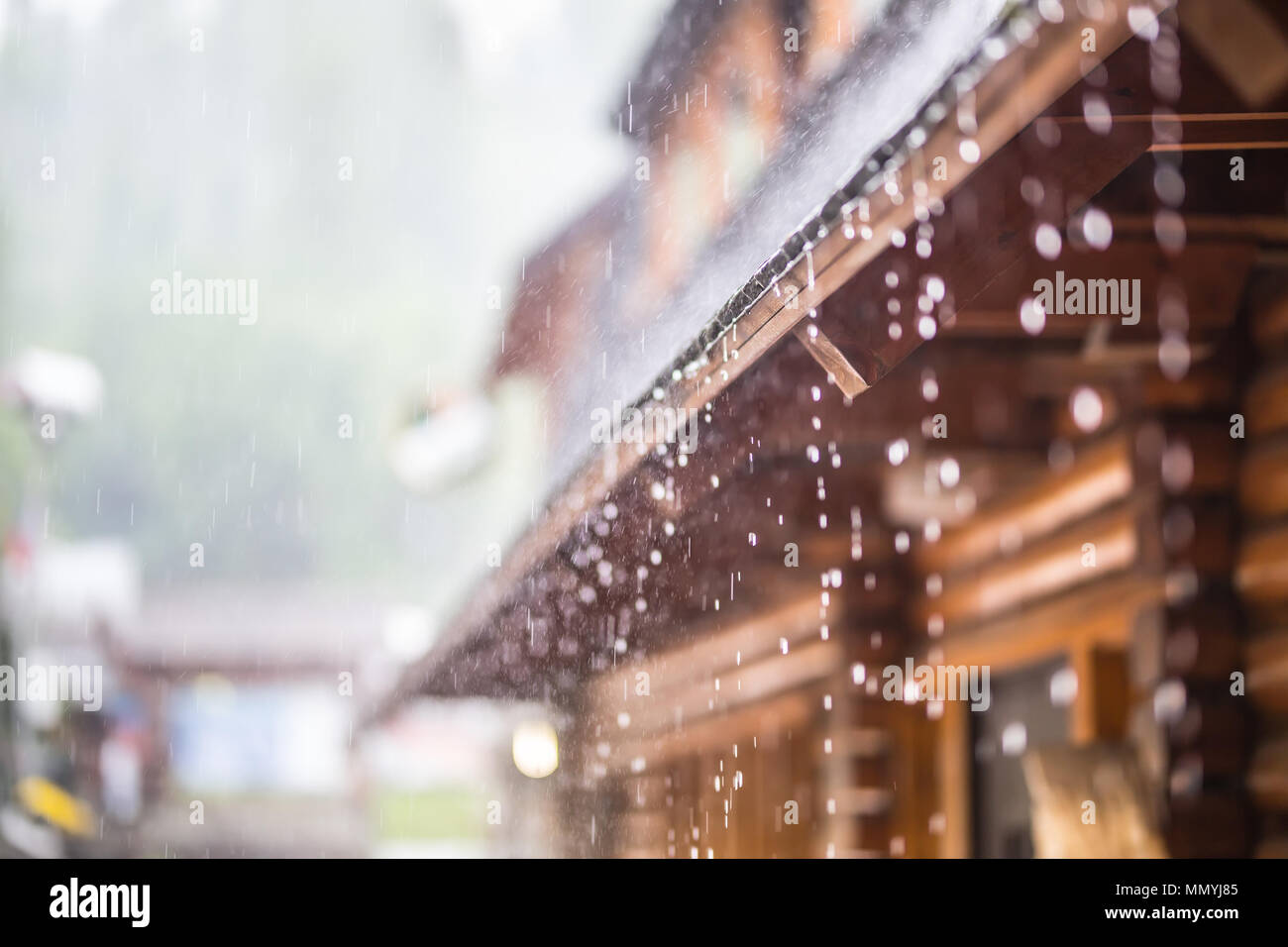 Downpour in the summer storm and rain drops on the roof. Stock Photo