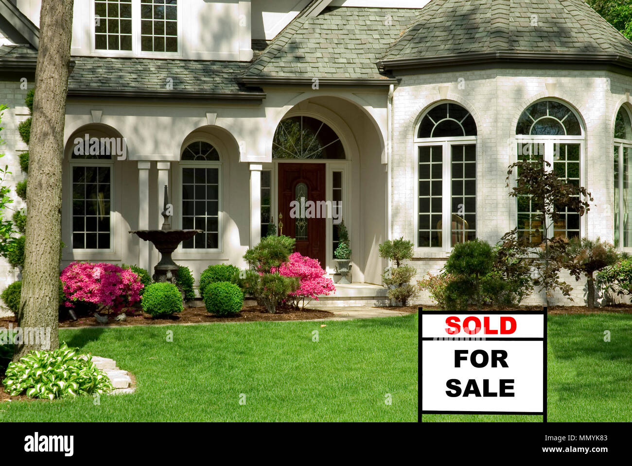 Beautiful white brick home featuring complex architectural details