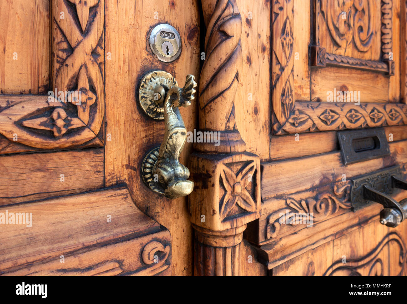 Brass door knocker on a hand carved wooden door in San Miguel de