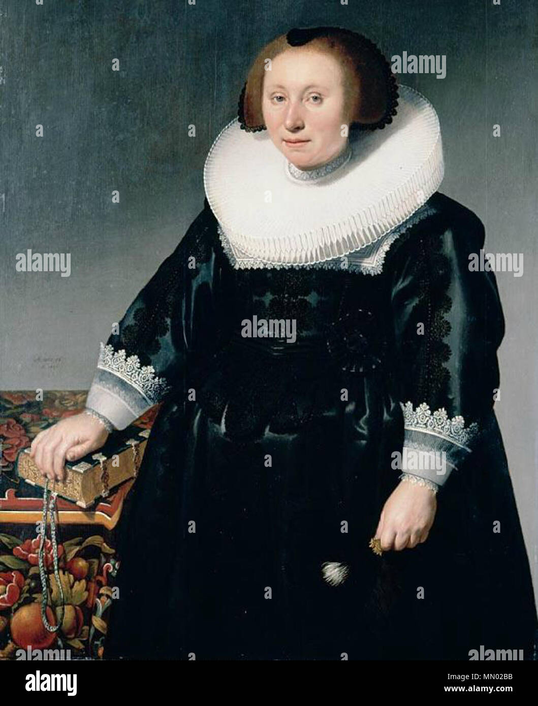 .  English: Portrait of a matronly lady in a black cap and black dress with white box collar facing left holding a book on a table with flowered table carpet.  Signed and  dated  centre  left:  'Ætatis.56/  A0.  1630/  HD  f', oil  on  panel, 124x92.6  cm.  . 1630. Herman Doncker - portrait of a lady in a box collar Stock Photo