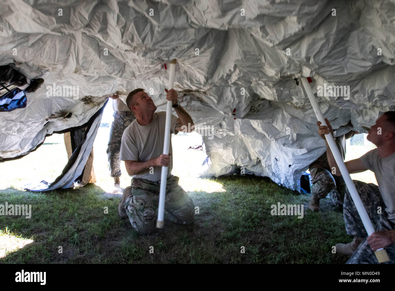 Spc. Robert Crocker, a Soldier in the Florida National Guard's 2nd Battalion, 111th Aviation Regiment (AOB) sets up a DRASH (Deployable Rapid Assembly Shelter) tent used as a field operations center during Operation Northern Strike, July 31, 2017. Operation Northern Strike is a two-week exercise that assesses the working knowledge of air-to-ground forces between the U.S.Army, Air Force and Marine units from around the country, as well as, Latvian, Great Britain, and Polish military personnel. Stock Photo