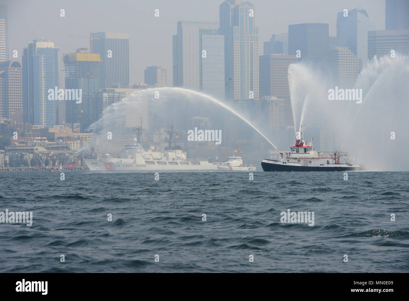 The Coast Guard Cutter Mellon is accompanied by Coast Guard Patrol Boat Sea Lion, and a Coast Guard Station Seattle response boat as they pass the Seattle Fire Department fireboat Leschi during the Parade of Ships in Elliott Bay for the 68th annual Seafair Fleet Week. Seafair Fleet Week is an annual celebration of the sea services wherein Sailors, Marines and Coast Guardsmen from visiting U.S. Navy and Coast Guard ships and ships from Canada make the city a port of call. U.S. Coast Guard photo by Petty Officer 3rd Class Valerie Walker Stock Photo