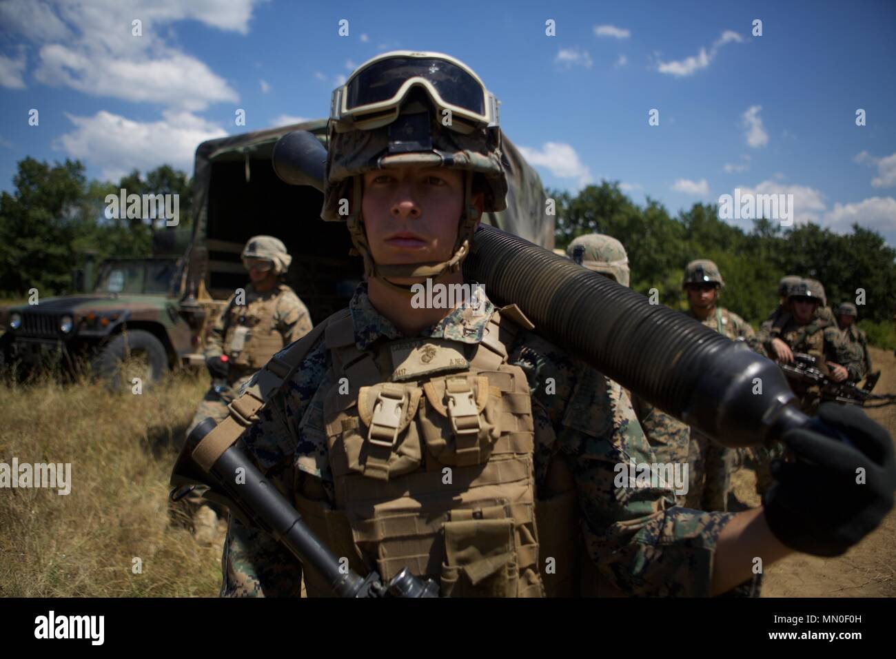 A U.S. Marine with Black Sea Rotational Force 17.1 carries an 81 millimeter mortar tube during an occupy by force rehearsal aboard Novo Selo Training Area, Bulgaria, Aug. 2, 2017. This range was a part of Exercise Platinum Lion 17.2, a multinational exercise to build relationships with NATO Allies and partner nations through combined arms training. (U.S. Marine Corps photo by Pfc. Sarah N. Petrock) Stock Photo