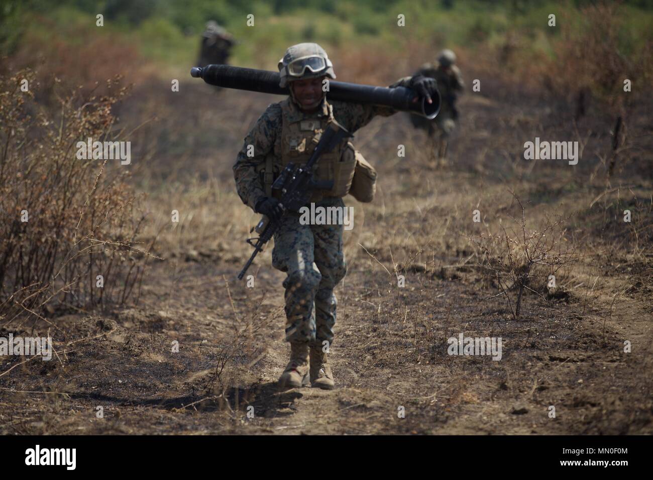 A U.S. Marine with Black Sea Rotational Force 17.1 carries a 81 milimeter mortar tube during an occupy by force rehearsal aboard Novo Selo Training Area, Bulgaria, Aug. 2, 2017. This range was a part of Exercise Platinum Lion 17.2, a multinational exercise to build relationships with NATO Allies and partner nations through combined-arms training. (U.S. Marine Corps photo by Pfc. Sarah N. Petrock) Stock Photo