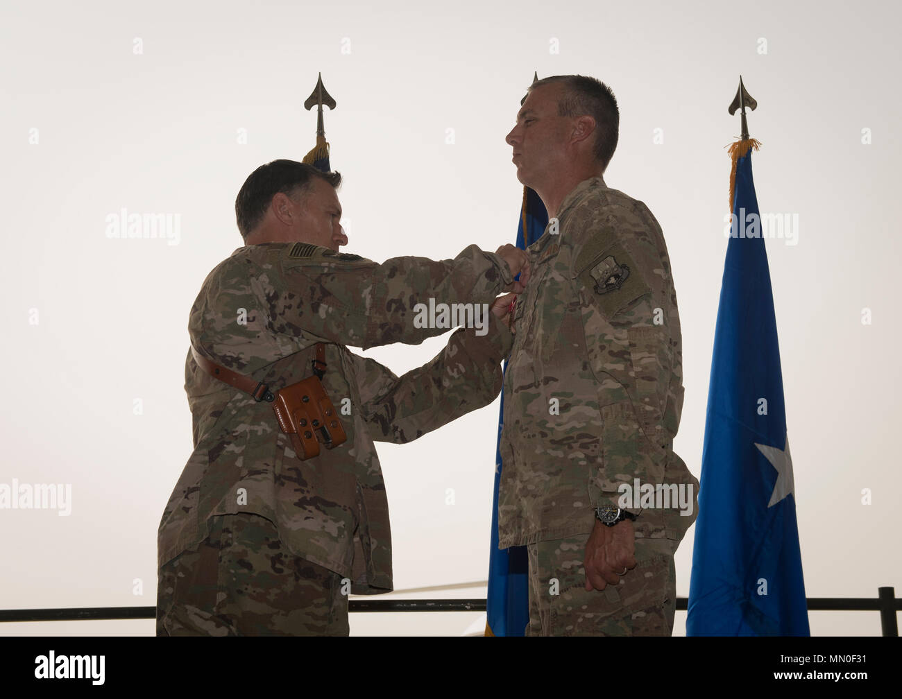Col. Craig Lucey, the outgoing 451st Air Expeditionary Group commander, receives the Bronze Star Medal from Brig. Gen. Craig Baker, the 455th Air Expeditionary Wing commander, during the 451st AEG change of command ceremony at Kandahar Airfield, Afghanistan, Aug. 2, 2017. Lucey commanded the 451st AEG for the last 12 months. During his time as commander, he led Airmen and civilians from four squadrons and managed the second largest airfield in Afghanistan. (U.S. Air Force photo by Staff Sgt. Benjamin Gonsier) Stock Photo