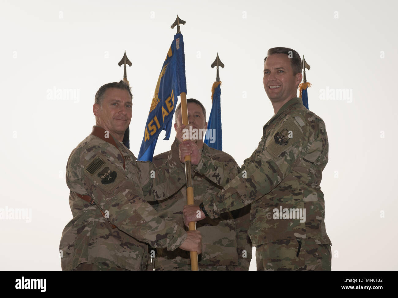 Col. Steve Jones, the incoming 451st Air Expeditionary Group commander, receives the 451st AEG guidon from Brig. Gen. Craig Baker, the 455th Air Expeditionary Wing commander, during the 451st AEG change of command ceremony at Kandahar Airfield, Afghanistan, Aug. 2, 2017. Jones is a command pilot with more than 3,400 flying hours and has flown the B-1B Lancer, MQ-1 Predator and MQ-9 Reaper. (U.S. Air Force photo by Staff Sgt. Benjamin Gonsier) Stock Photo