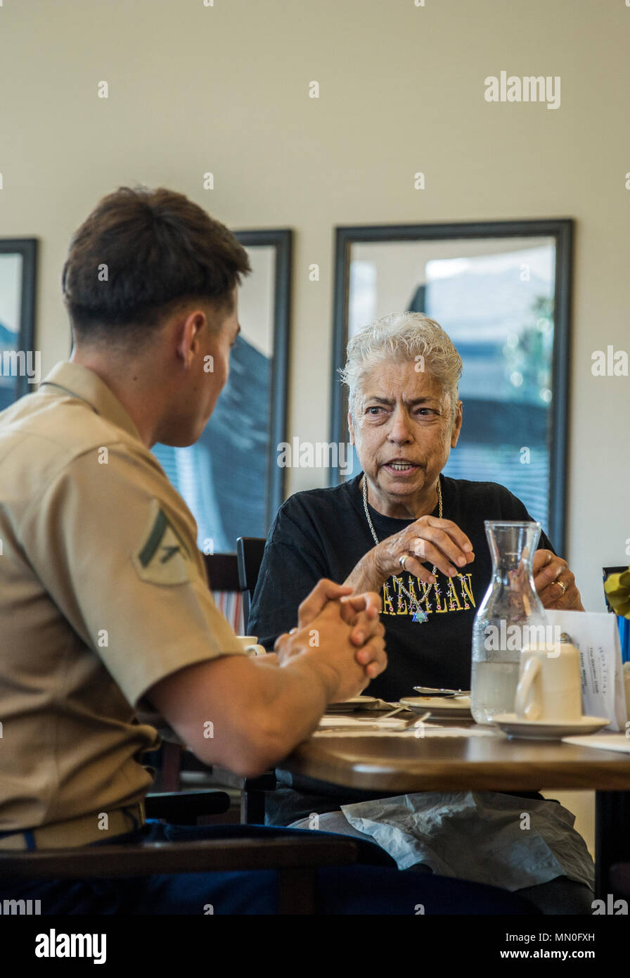 Linda Stahl shares stories about her life with Marine Lance Cpl. Kyle Waters during a volunteer event at Garden Club Senior Retirement Home during Seattle Seafair August 4, 2017. Seattle Seafair is an annual event where hundreds of Marines and Sailors come to showcase the capabilities of the Navy-Marine Corps team to residents, and an opportunity for members of the sea services to meet and thank the community for its support. Waters is a light armored reconnaissance vehicle operator, Company C, 3rd LAR Battalion, 1st Marine Division stationed at Marine Air-Ground Combat Center Twentynine Palms Stock Photo