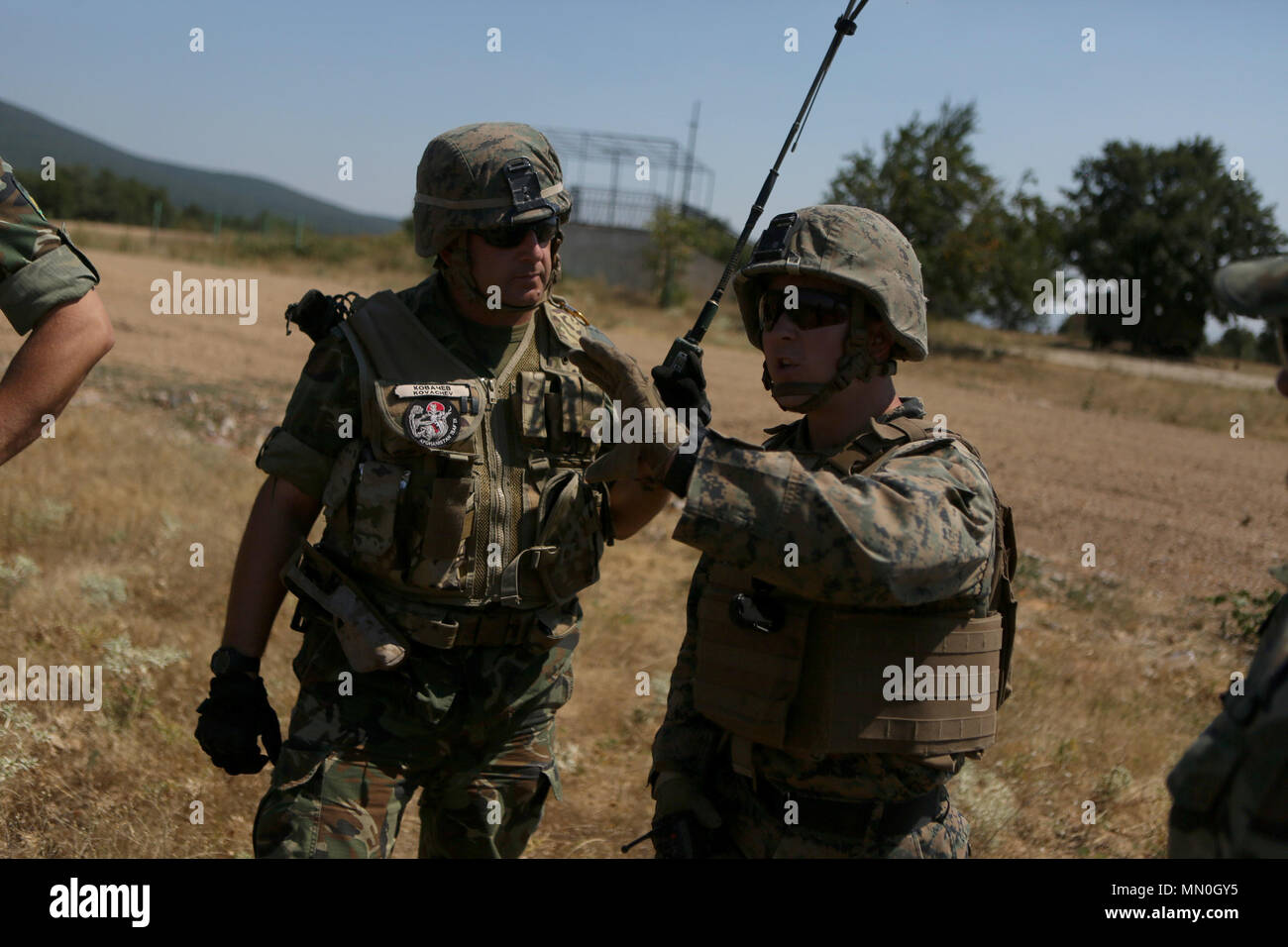 A U.S. Marine with Black Sea Rotational Force 17.1 and a Bulgarian soldier discuss tactics during a combined anti-armor range aboard Novo Selo Training Area, Bulgaria, Aug. 3, 2017. The event was part of Platinum Lion 17.2, a multinational exercise to increase interoperability between NATO Allies and partner nations through combined-arms training. (U.S. Marine Corps photo by Cpl. Sean J. Berry) Stock Photo