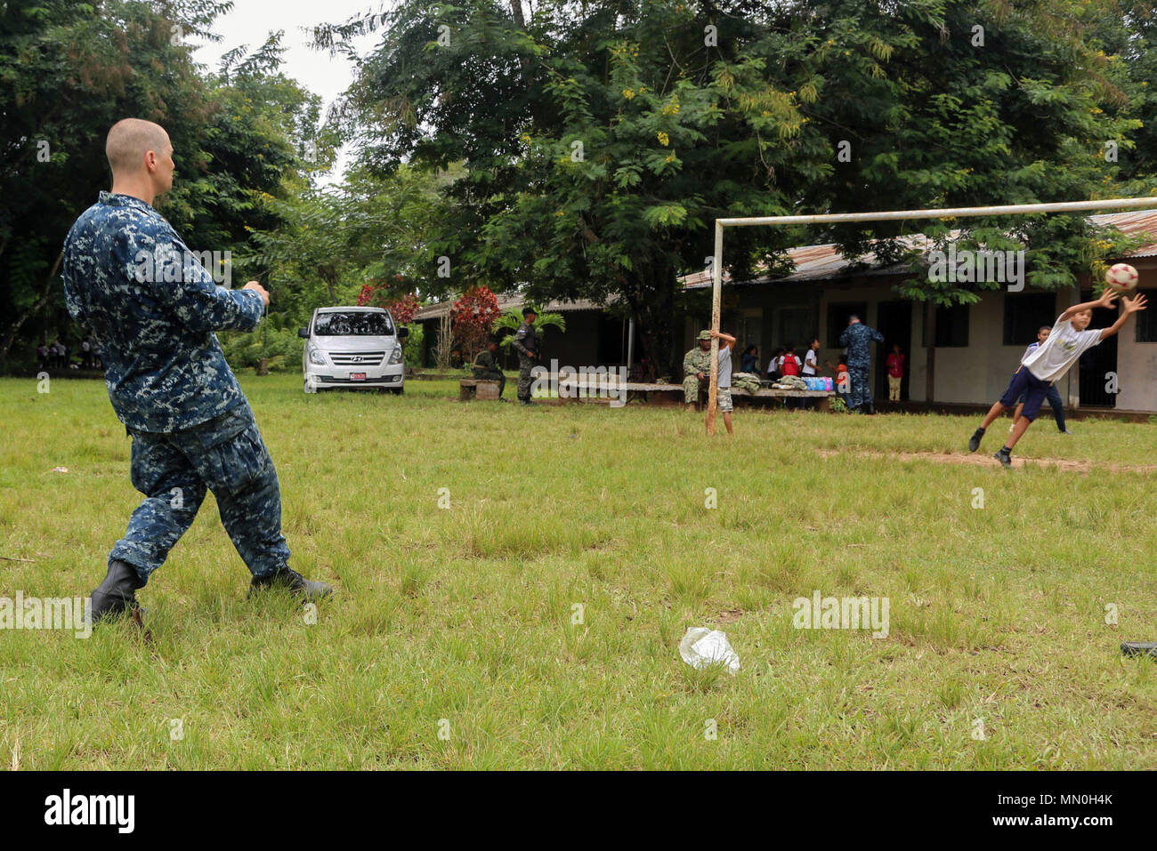 170804-A-QE286-409 TARROS, Honduras (Aug. 4, 2017) U.S. Navy Lt. Cmdr. Ian Sutherland, technical director for the Navy Entomology Center of Excellence, plays soccer with Honduran elementary school students at Escuela Rural Mixta Luz Infantil, during a Southern Partnership Station 17 community relations (COMREL) project. SPS-EPF 17 is a U.S. Navy deployment, executed by U.S. Naval Forces Southern Command/U.S. 4th Fleet, focused on subject matter expert exchanges with partner nation militaries and security forces in Central and South America. (U.S. Army photo by SPC Judge Jones/Released) Stock Photo