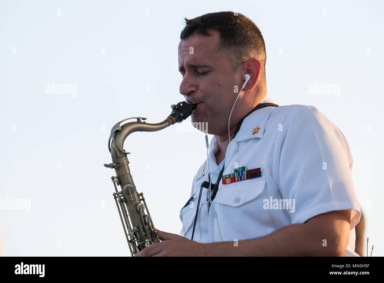 COLLEGE STATION, Texas (Aug. 6, 2017) Musician 1st Class Manuel Palayo De Gongora performs with the U.S. Navy Band Cruisers popular music group at Veterans Park and Athletic Complex in College Station, Texas. The U.S. Navy Band performed in four states during its 14-city national tour, connecting the Navy to communities that don't see Sailors at work on a regular basis. (U.S. Navy photo by Chief Musician Adam Grimm/Released) Stock Photo