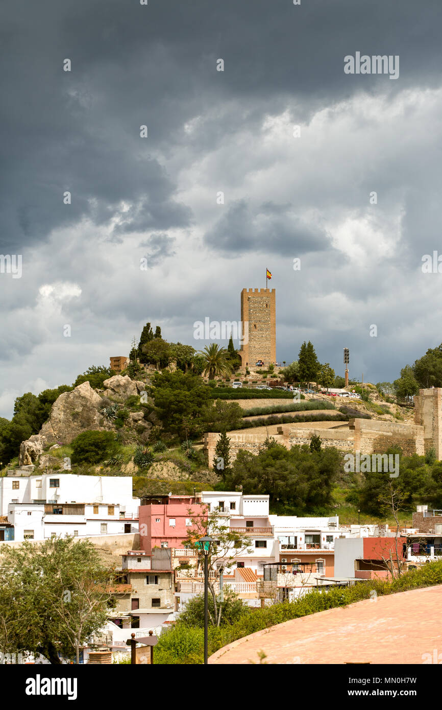 Dark rain clouds over  the Arabic castle tower (Torre del Homenaje), Velez Malaga, Stock Photo